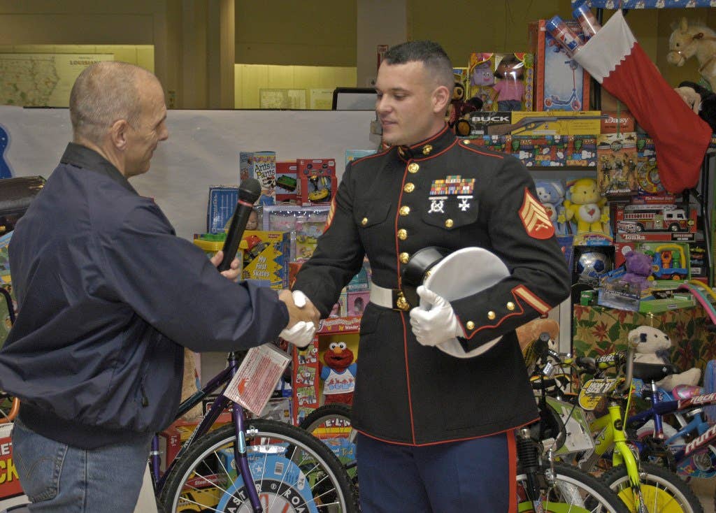A U.S. Marine takes donations for Toys for Tots in the days following Hurricane Katrina (Photo from FEMA)
