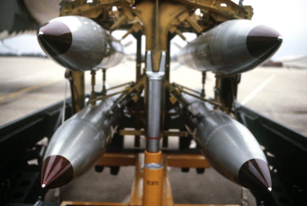A front view of four nuclear free-fall bombs on a bomb cart. (Image from Wikimedia Commons)