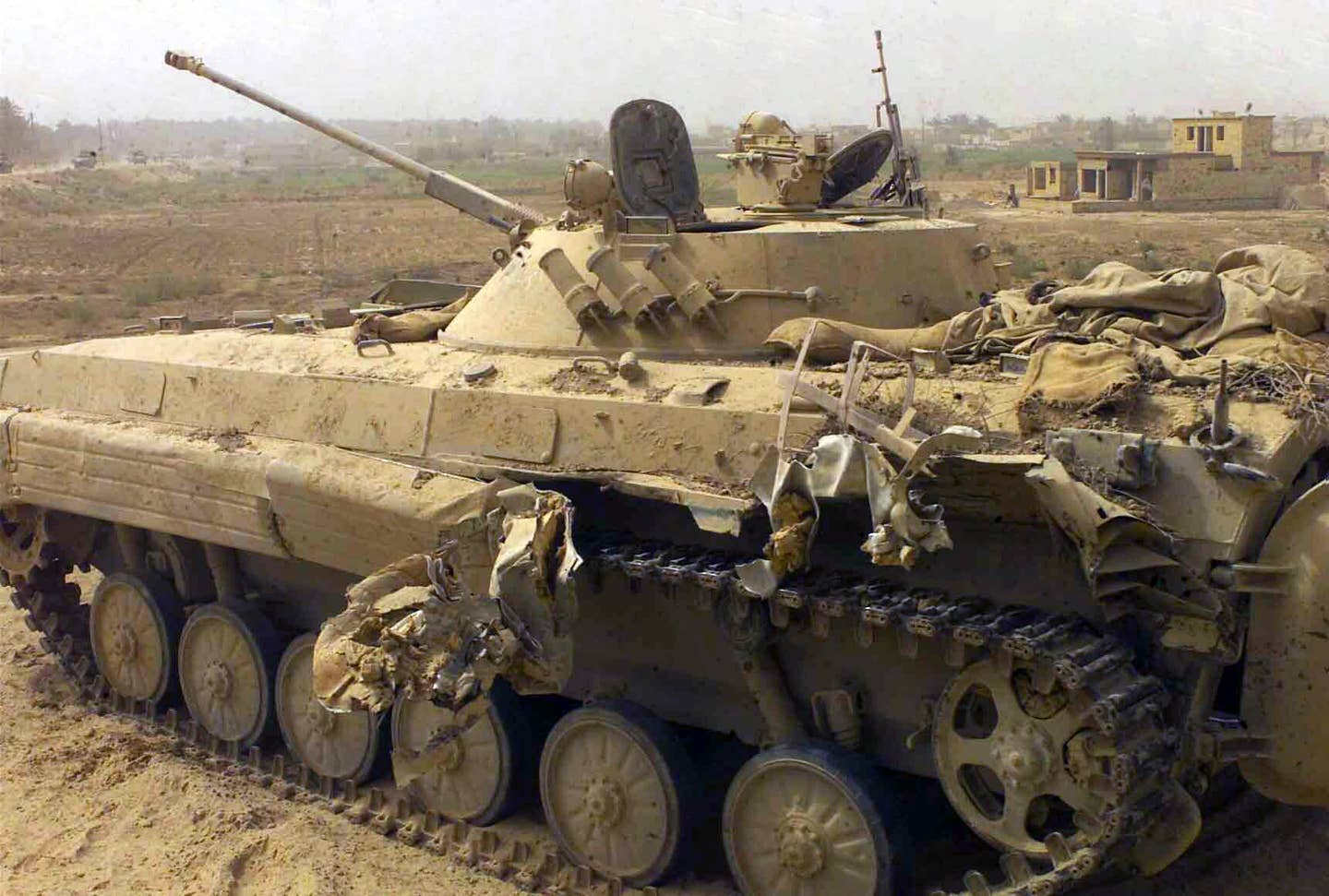 A partially destroyed abandoned Iraqi BMP-2 Infantry Fighting Vehicle sits along a roadside in Northern Iraq, during Operation Iraqi Freedom.