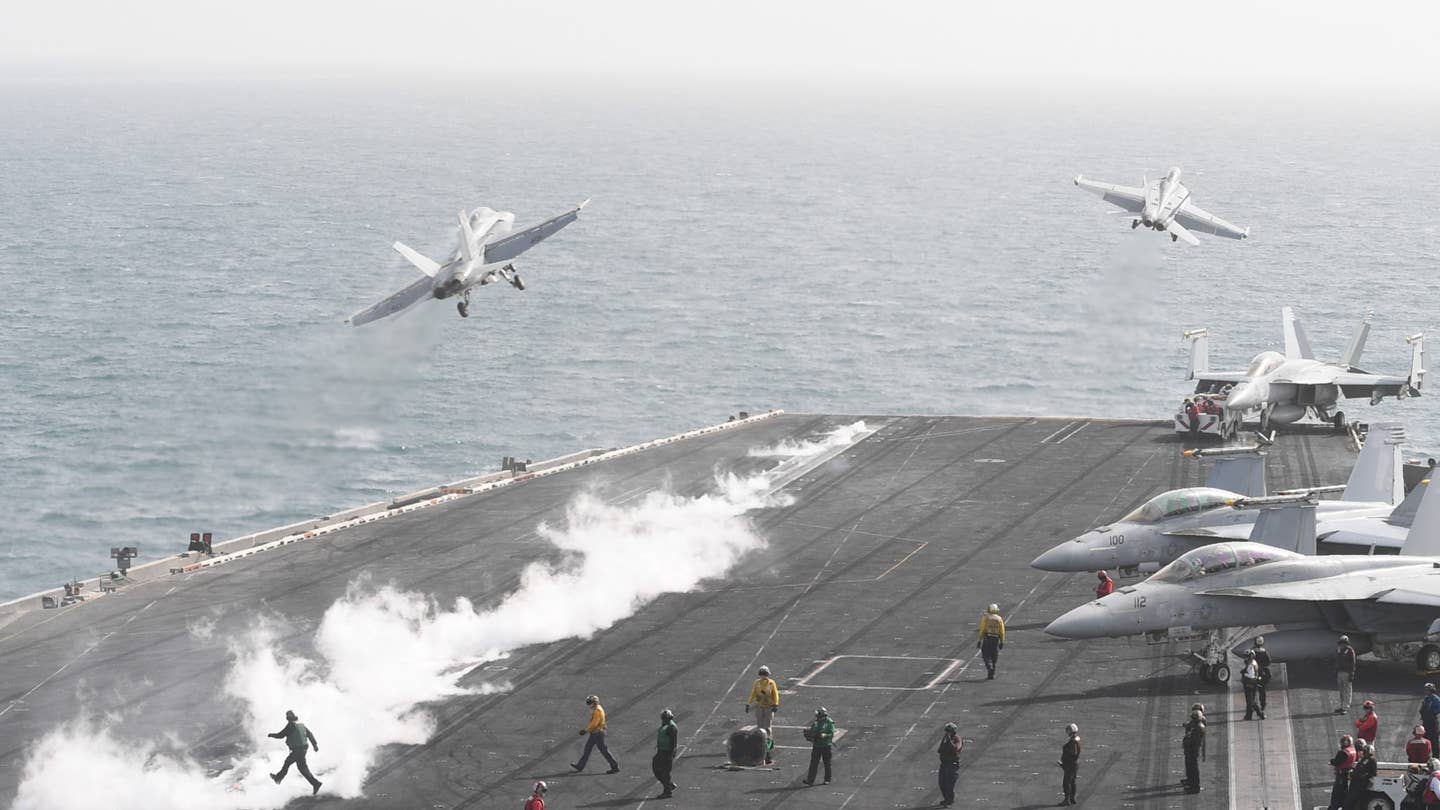 A F/A-18F Super Hornet, left, assigned to the Mighty Shrikes of Strike Fighter Attack Squadron 94, and an EA-18G Growler assigned to the Cougars of Electronic Attack Squadron 139 launch from the flight deck of the aircraft carrier USS Theodore Roosevelt. (U.S. Navy photo by Mass Communication Specialist 3rd Class Victoria Foley)