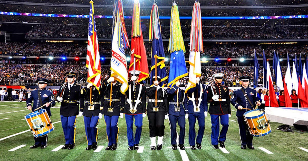 Members of the Armed Forces Color Guard and drummers from the U.S. Air Force Band, all based in Washington, D.C., perform during the Super Bowl XLV game at Cowboys Stadium in Arlington, Texas, Feb. 6, 2011. The Green Bay Packers defeated the Pittsburgh Steelers 31-25. (Image from Wikipedia Commons)
