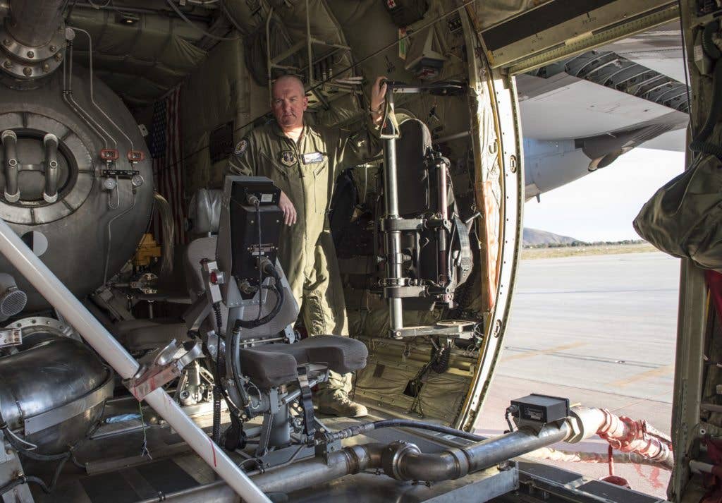 Senior Master Sgt. Phil Poulsen, 146th Airlift Wing loadmaster, checks the level of retardant in the module airborne firefighting system as redardant is loaded, Dec. 9, 2017. The 146th AW is one of five wings in the Air Force equipped with MAFFS. This system is loaded onto C-130s and is designed to fight wildfires. (U.S. Air Force photo/Master Sgt. Brian Ferguson)