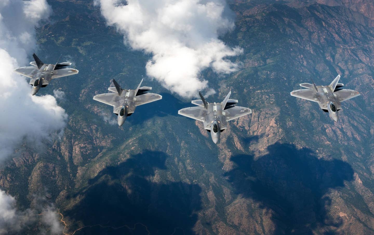 A four-ship formation of F-22 Raptors from the 94th Fighter Squadron and 1st Fighter Wing fly in formation over the Rocky Mountains in Colorado. The four aircraft were in transit back to Joint Base Langley-Eustis, Va. after participating in Red Flag 17-4 Aug. 26, 2017. (U.S. Air Force photo)