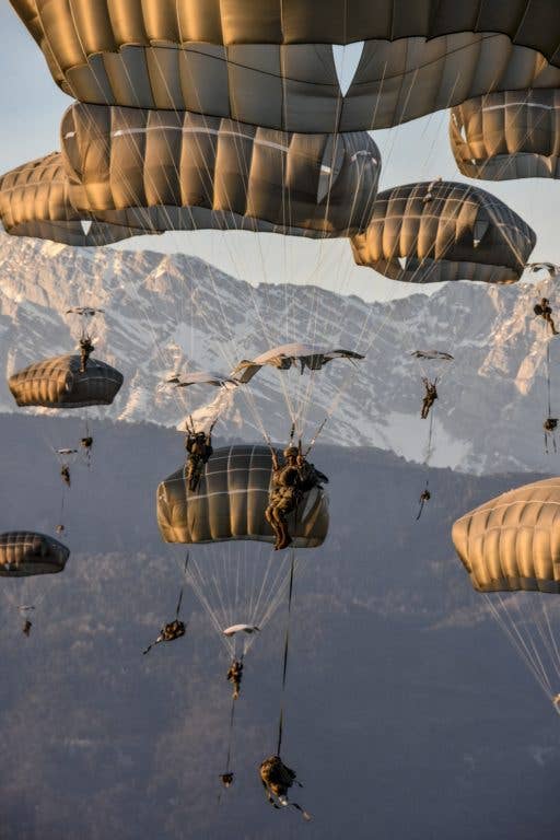 Hundreds of 173rd Airborne Brigade paratroopers conduct a tactical airborne insertion exercise onto Juliet Drop Zone in northern Italy, Jan. 24, 2018. (Photo Credit: Army photo by Lt. Col. John Hall )