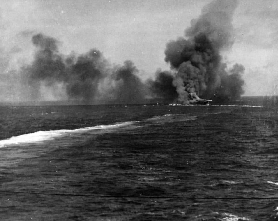 USS Intrepid burning after taking two Japanese kamikaze strikes.