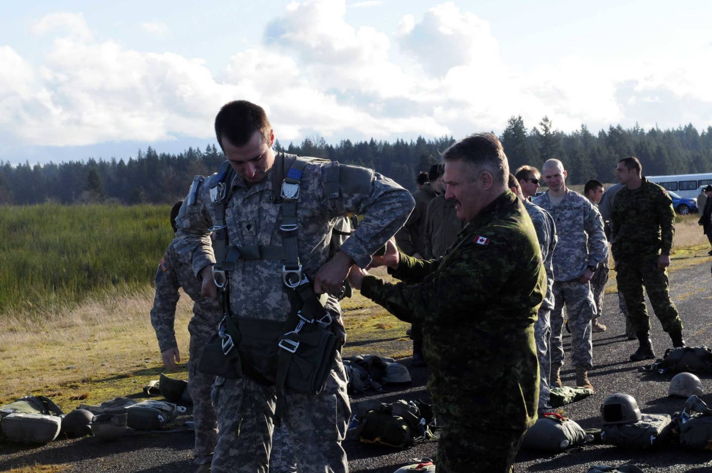 Members of 1st Special Forces Group (Airborne) and the Canadian Special Operations Regiment conducted a combined airborne operation and wing-exchange ceremony at Roger's drop zone on Joint Base Lewis-McChord, Wash. (Photo by Sgt. Elayseah Woodard-Hinton, 20th Public Affairs Detachment)