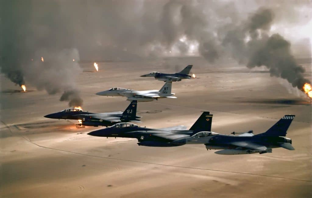 U.S. Air Force F-15s and F-16s fy over the burning oil fields of Kuwait. (Photo from U.S. Air Force)