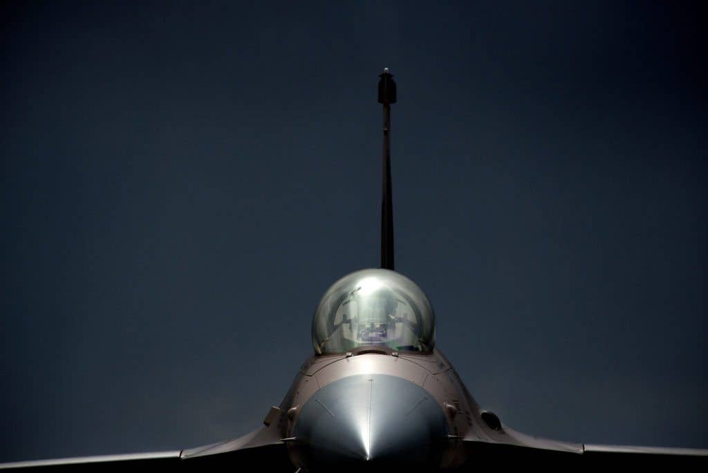 An F-16 Fighting Falcon goes through final inspection at the end of the runway before flying an exercise Red Flag 15-2 training mission. (U.S. Air Force photo by Master Sgt. Jeffrey Allen)