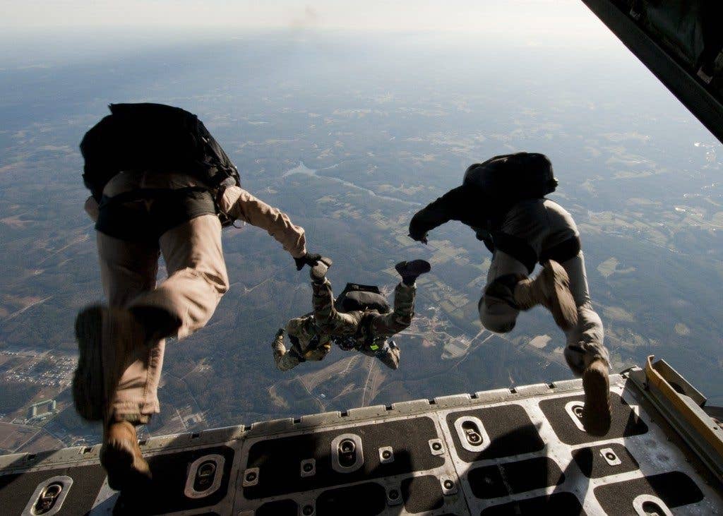 U.S. Navy SEALs exit a C-130 Hercules aircraft during a training exercise near Fort Pickett, Va.