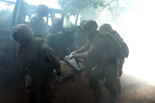 These Marines pull their wounded patient from a vehicle during the live-tissue training course.