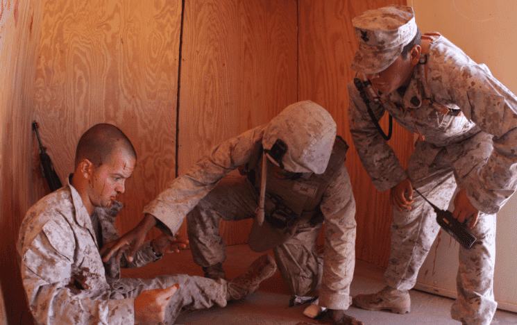 Marines with 3rd Battalion, 8th Marine Regiment treat casualties from at mock explosion during a first responder drill in a mock Afghan town at Range 215, as part of Mojave Viper. (Image from Wikimedia Commons)