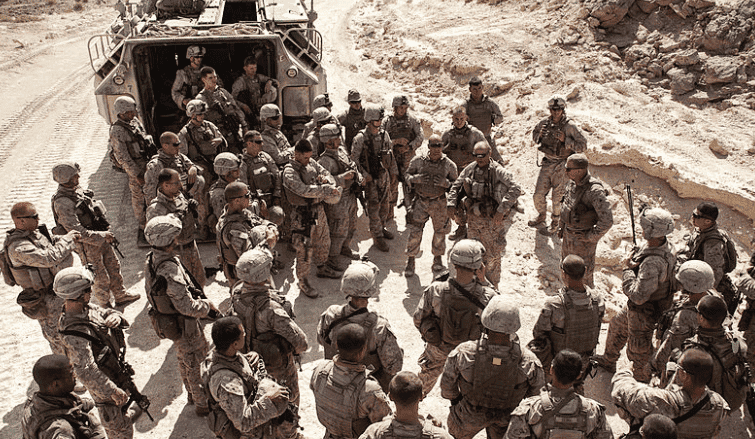 Staff Sgt. Tom Painter, a section leader with Amphibious Assault Vehicle Platoon debriefs his Marines after conducting a field exercise. (Photo from Wikimedia Commons)