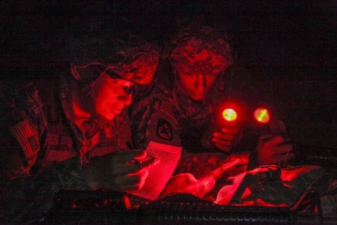 The red filters forced mapmakers to change the way they printed the maps, making them easier to read under red light. (Photo by Spc. Jeffery Harris)