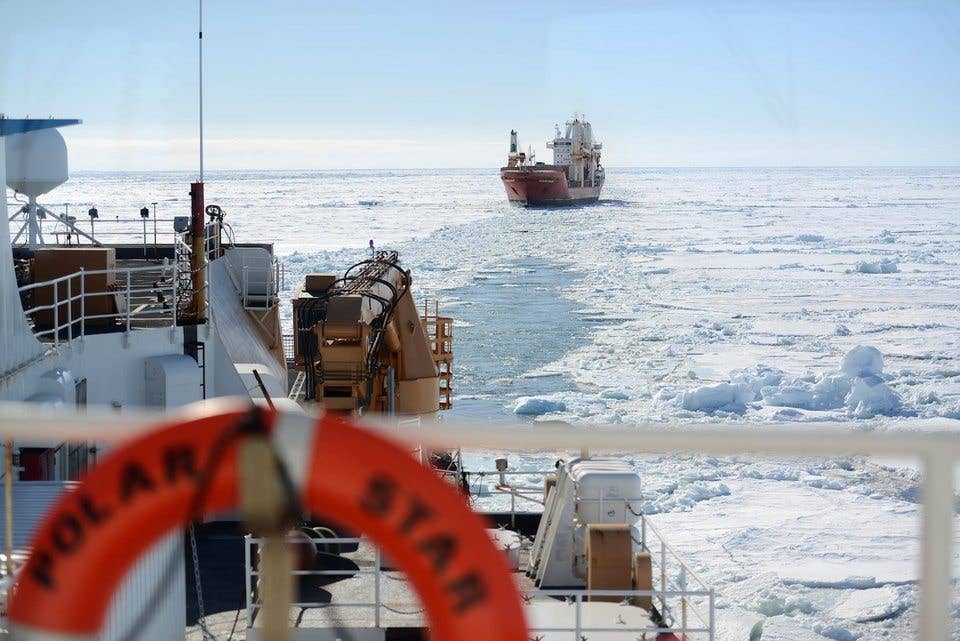 The crew of the motor vessel Ocean Giant lines up with the US Coast Guard Cutter Polar Star to be escorted to the National Science Foundation's McMurdo Station, Jan. 25, 2017. (US Coast Guard/Chief Petty Officer David Mosley)