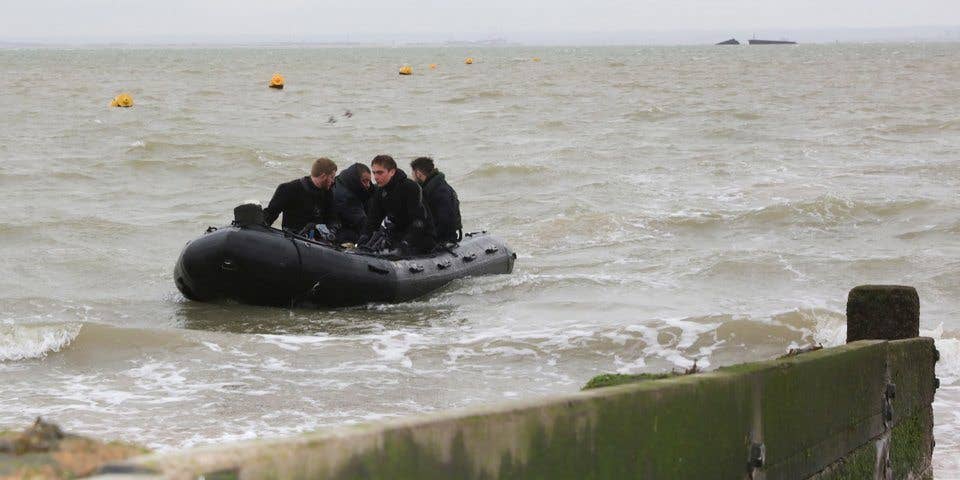 A Royal Navy bomb disposal team return to the shore after destroying the bomb. (Crown Copyright)