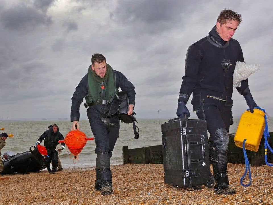 Royal Navy bomb disposal experts return after detonating the device. (Crown Copyright)