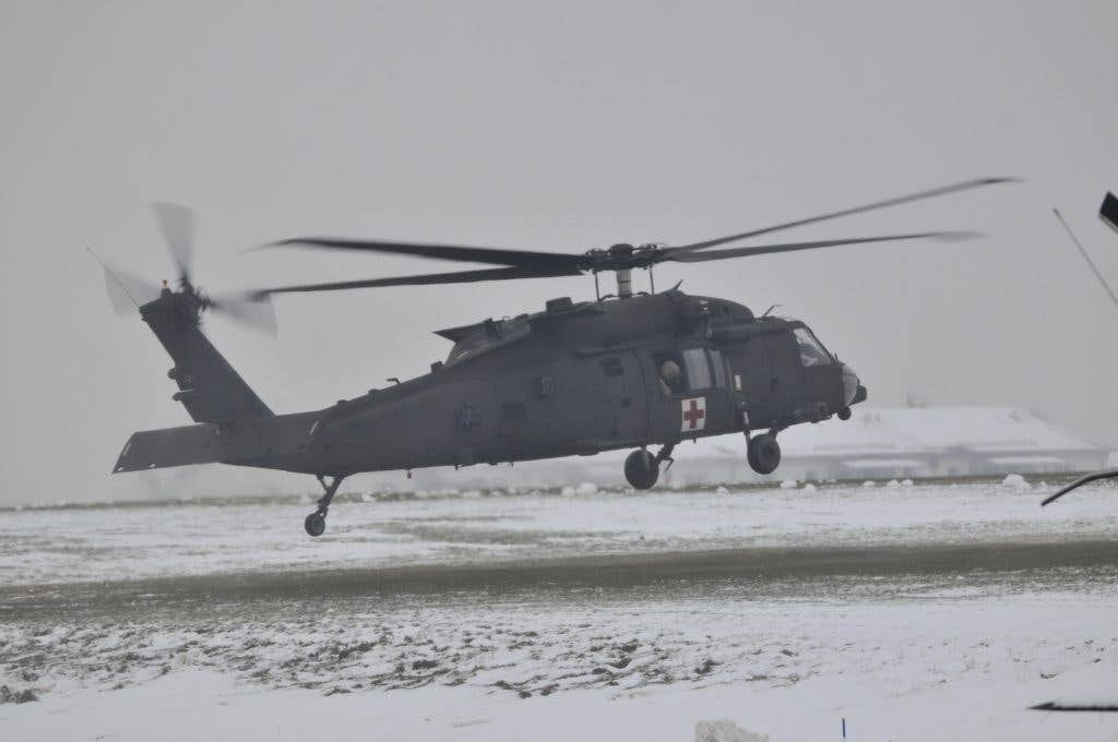 A U.S. Army HH-60 MEDEVAC helicopter from the 1st Air Cavalry Brigade from Fort Hood Texas conducts a traffic pattern training flight Dec. 19, 2017, at Katterbach Army Airfield in Ansbach, Bavaria, Germany. One item of concern for treating wounded troops is the fact that Navy and Marine Corps medical equipment might not be interoperable with that of the Army of Air Force. (U.S. Army photo by Charles Rosemond)