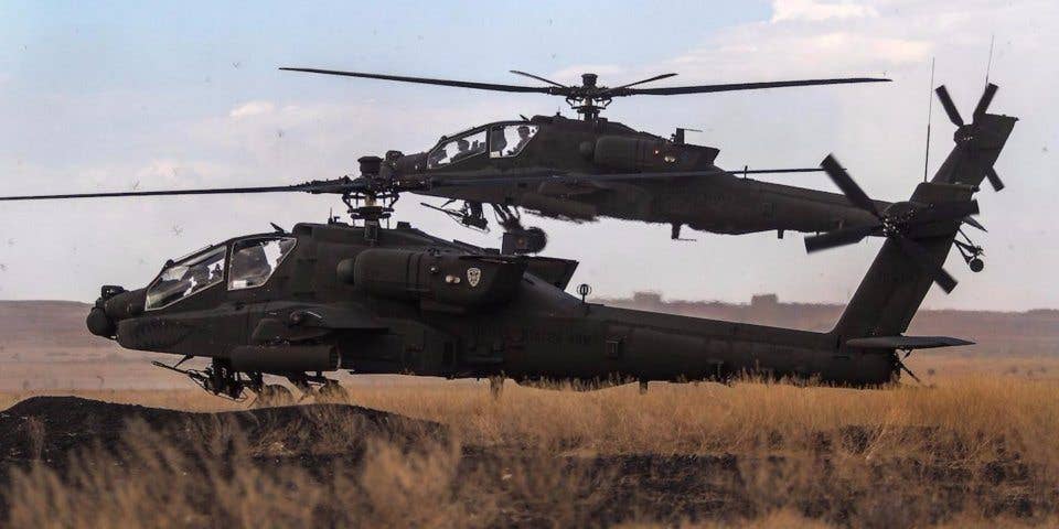 Two AH-64E Apache helicopters prepare to land at Orchard Combat Training Center, Idaho, Sept.29, 2016. (US Department of Defense)