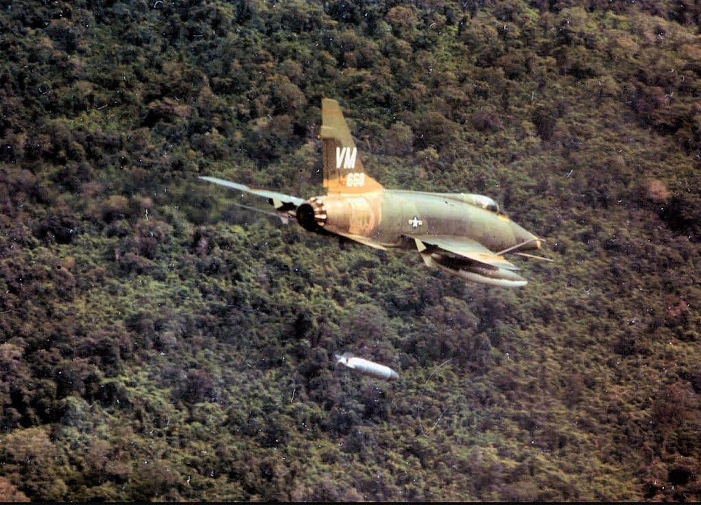 A North American F-100D Super Sabre drops napalm on enemy positions. This plane hung around with the Air National Guard as a fighter-bomber until 1979! (USAF photo)