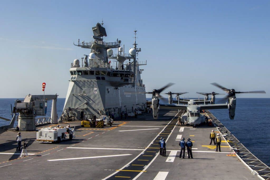 Three MV-22B Ospreys with Special-Purpose Marine Air-Ground Task Force Crisis Response-Africa participate in deck landing qualifications aboard a Spanish amphibious assault ship Juan Carlos I (L61) on the southern coast of Spain, Oct. 21. U.S. Marines and Spanish sailors practice deck procedures including tie-downs, taxiing and refueling the aircraft. (U.S. Marine Corps photo by Staff Sgt. Vitaliy Rusavskiy)