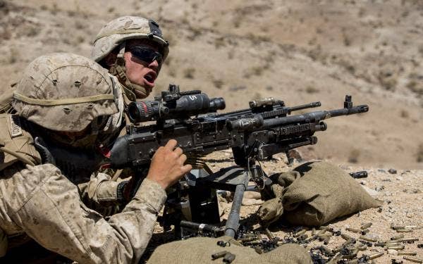 Lance Cpl. Eric Lewis (left) shouts out commands to machine gunners during a platoon-size live fire range as part of Exercise Desert Scimitar 2014 aboard Marine Corps Air Ground Combat Center Twentynine Palms, Calif. (U.S. Marine Corps photo by Sgt. Luis A. Vega)
