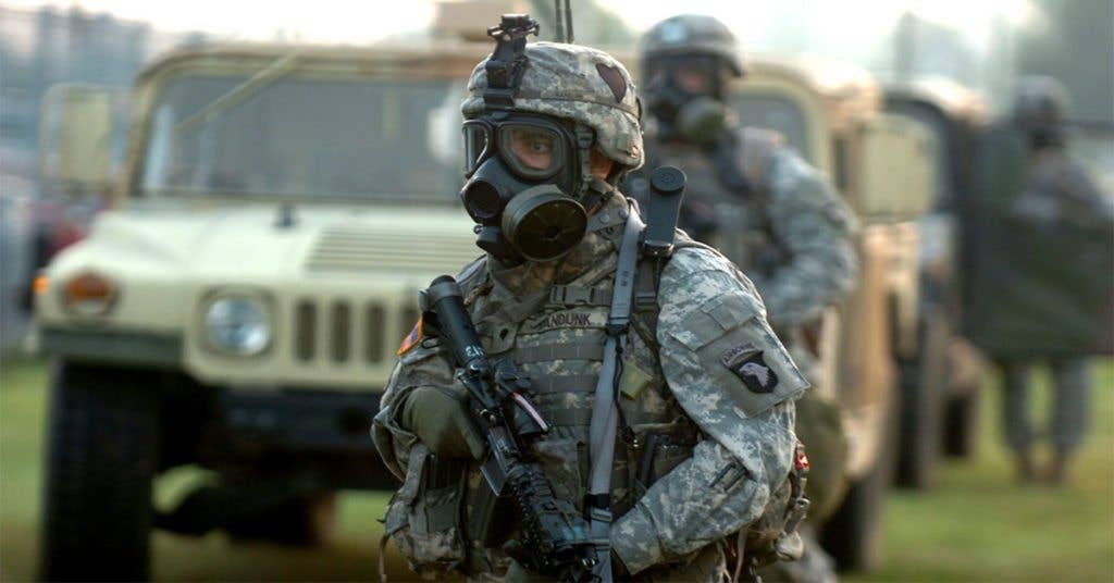 U.S. Soldiers with Headquarters and Headquarters Company, 2nd Battalion, 502nd Infantry Regiment, 2nd Brigade Combat Team, 101st Airborne Division (Air Assault) wear M-40 gas masks during a recovery scenario at Fort Campbell. (Photo by Spc. Joe Padula)