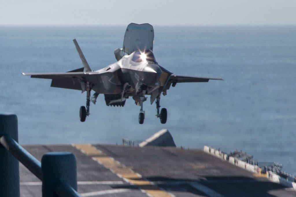 A U.S. Marine Corps F-35B Lightning II aircraft assigned to Marine Fighter Attack Squadron (VMFA) 211, Marine Aircraft Group 13, 3rd Marine Aircraft Wing, descends to the flight deck of the amphibious assault ship USS Essex (LHD 2) during Exercise Dawn Blitz. (U.S. Marine Corps photo by Lance Cpl. Roderick Jacquote)