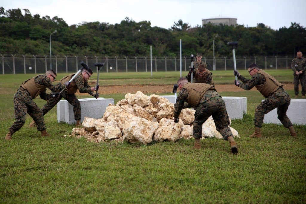 Brig Marines simulate hard labor during a Correctional Custody Unit demonstration Jan. 12 in the Brig aboard Camp Hansen, Okinawa, Japan. (U.S. Marine Corps photo by Sgt. Jessica Collins)