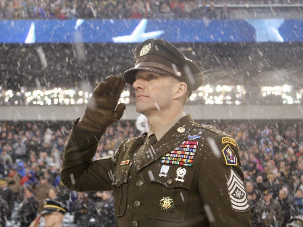 Sergeant Major of the Army Dan Dailey salutes the Anthem pre-kickoff during the Army-Navy game at Lincoln Financial Field. SMA Dailey displayed the Army's proposed 'Pink and Green' daily service uniform, modeled after the Army's standard World War II-era dress uniform. (U.S. Army photo by Ronald Lee)