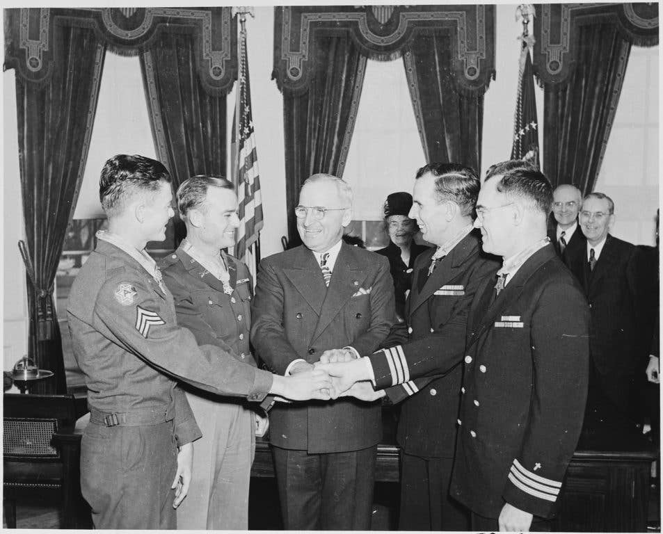 McKinney (left) received the Medal of Honor from President Truman for his actions that day.