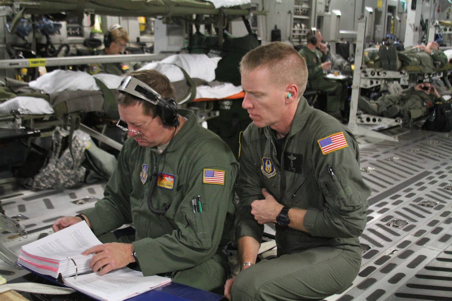 Master Sgt. Russel Goodwater and Master Sgt. Timothy Starkey assess their checklist for proper protocol during a AE training mission. (photo by Master Sgt. Christian Amezcua)