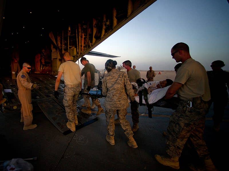 CASF personnel litter carry a patient from an ambulance bus onto C-17 aircraft at Camp Bastion, Afghanistan. (U.S. Air Force photo/ Master Sergeant Adrian Cadiz)