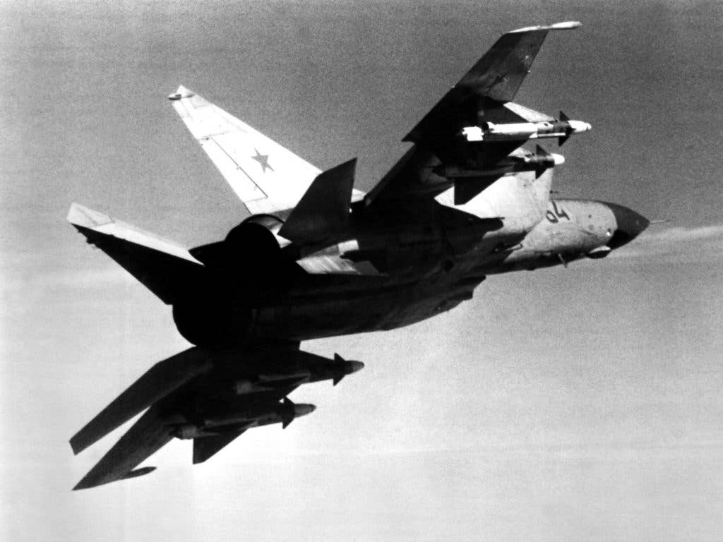 An air-to-air right underside rear view of a Soviet MiG-25 Foxbat aircraft carrying four AA-6 Acrid missiles. (DOD photo)