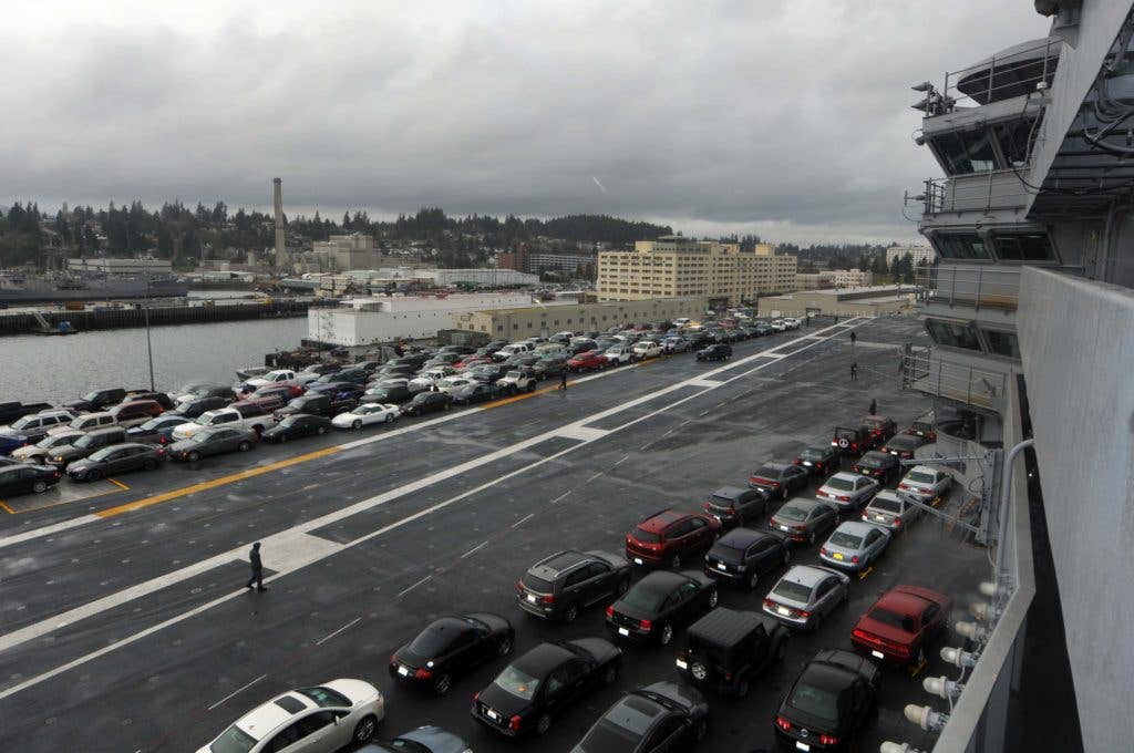 Sailors' vehicles are parked on the flight deck of the aircraft carrier USS Ronald Reagan (CVN 76). (U.S. Navy photo by Mass Communication Specialist 3rd Class Charles D. Gaddis IV)