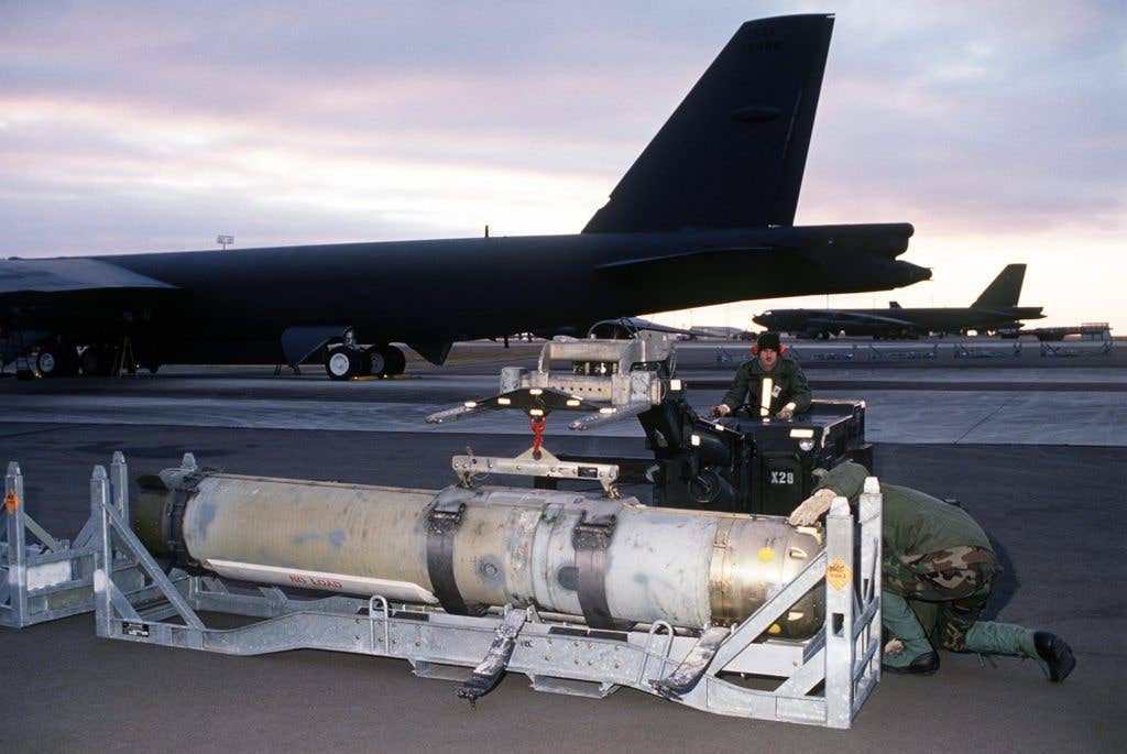 Airmen from the 42nd Munitions Maintenance Squadron prepare to load a Mark 60 CAPTOR (encapsulated torpedo) anti-submarine mine onto a 42nd Bombardment Wing B-52G Stratofortress aircraft during Ghost Warrior, a joint Air Force/Navy exercise conducted during the base's conventional operational readiness inspection. (USAF photo)