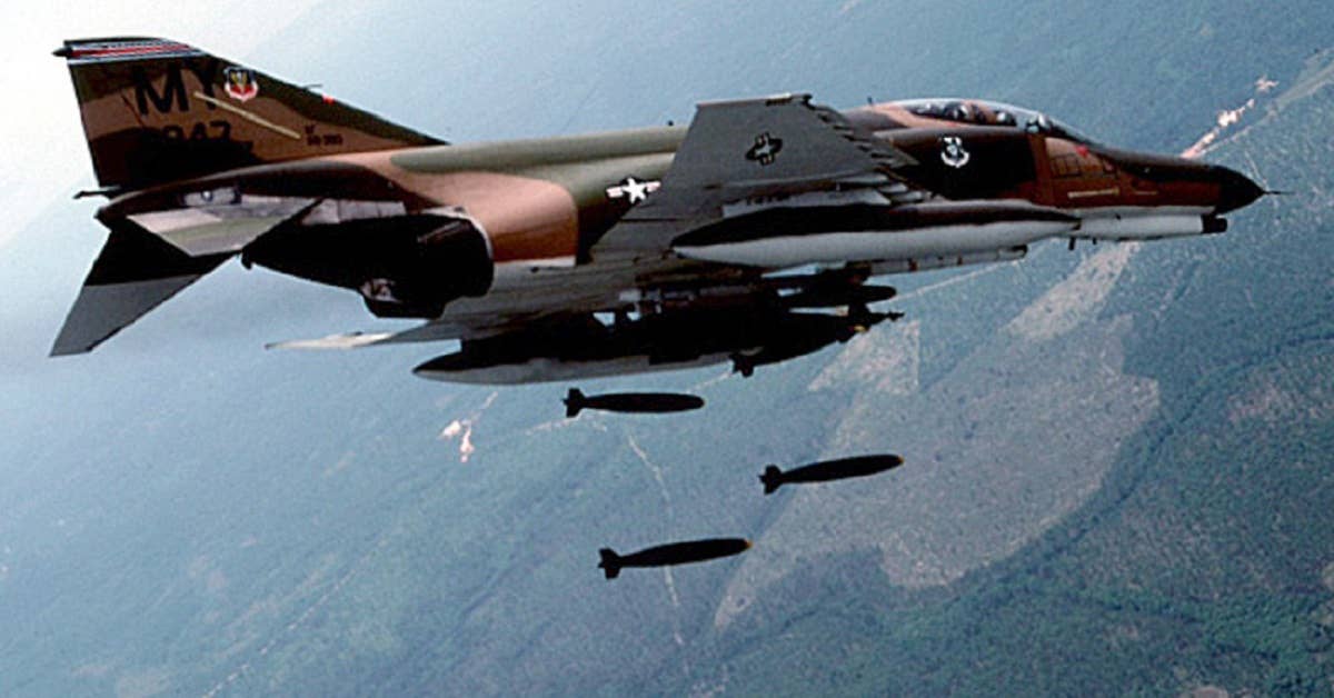 A F-4 Phantom drops bombs on a target. (Photo by USAF)