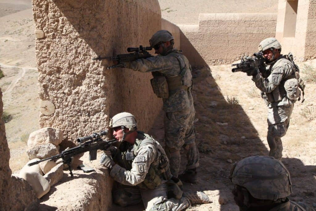 U.S. Soldiers with 3rd Platoon, Alpha Company, 1st Battalion, 503rd Infantry Regiment, 173rd Airborne Brigade Combat Team prepare to engage enemy combatants in Chak district, Wardak province, Afghanistan. The kneeling soldier has an M14 Enhanced Battle Rifle, which is being replaced by the M110A1. (DoD photo by Pfc. Donald Watkins, U.S. Army)