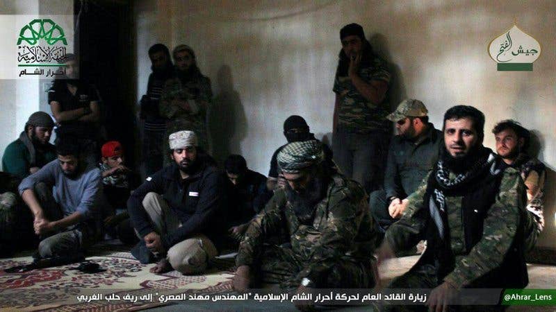 The general commander of Ahrar al-Sham, Mohannad al-Masri, center, visiting fighters in rural western Aleppo, Syria. (Militant Photo)
