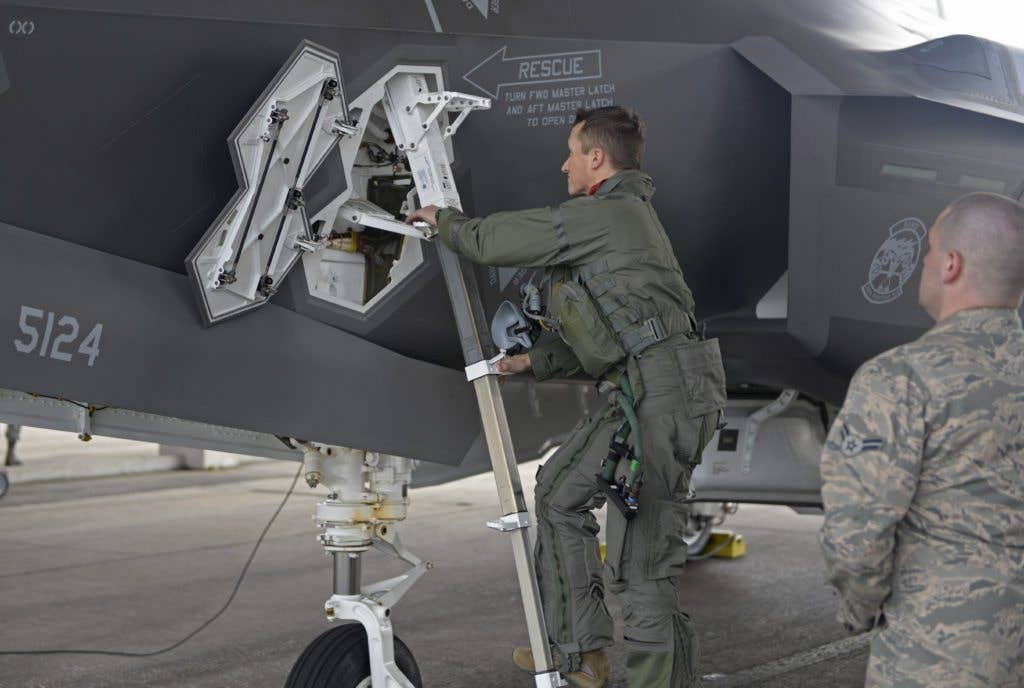 The head of the pilot boarding this F-35A Lightning slightly obscures the instructions for operating a rescue handle. (U.S. Air Force photo by Staff Sgt. Benjamin Sutton)