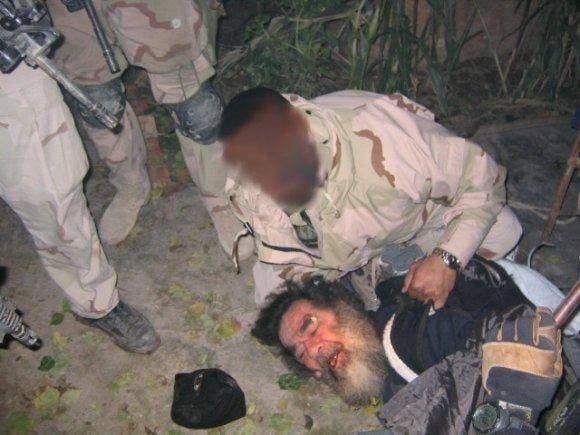 The Ace in the Hole: Saddam Hussein is found hiding in a small hole in the ground on December 13, 2003