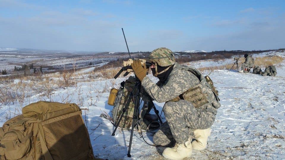Spc. Tyler Carlson gets ready to scan for targets using the Joint Effects Targeting System Target Location Designation System during testing at the Cold Regions Test Center, Fort Greely, Alaska. (Photo by Scott D. McClellan/US Army Operational Test Command)