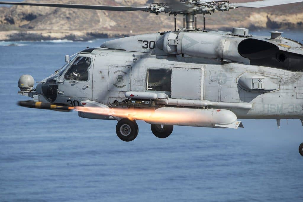 A Sikorsky MH-60R Sea Hawk helicopter, assigned to Helicopter Maritime Strike Squadron (HSM) 35, fires an AGM-114M Hellfire missile near San Clemente Island, Calif., during a live-fire combat training exercise. (U.S. Navy Combat Camera photo by Mass Communication Specialist 2nd Class Arthurgwain L. Marquez)