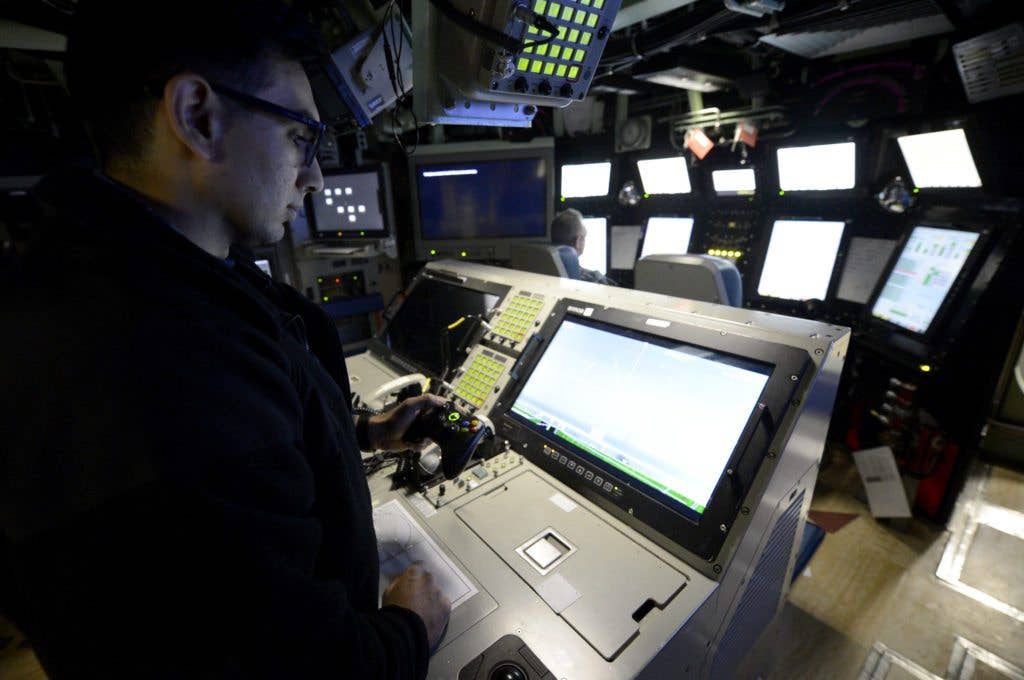 Lt. Anthony Matus uses an XBox controller to maneuver the photonic mast aboard Pre-Commissioning Unit Colorado. (U.S. Navy photo by Mass Communication Specialist 1st Class Jeffrey M. Richardson)