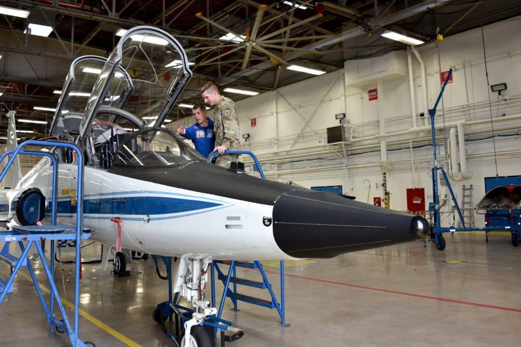 Retired Army Col. Shane Kimbrough, NASA astronaut, describes some of the features of the T-38 jet which is used to train astronauts for spaceflight. (U.S. Army photo by Ms. Dottie K. White)