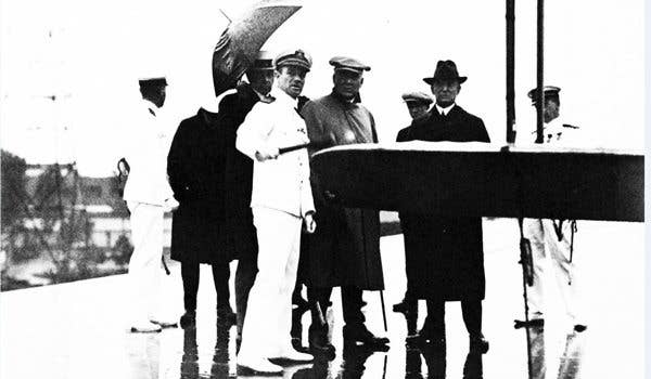 President Warren G. Harding with Navy Cmdr. Kenneth Whiting, Secretary of the Interior Hubert Work and RAdm. William A. Moffett on the flight deck of USS Langley, 1922-23. (Navy photo, now in the collections of the National Archives)
