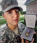 Sgt. Leigh Hester holds up her Silver Star.