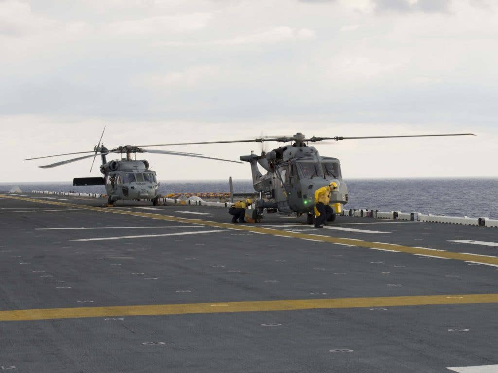 A Wildcat HMA.2 of the Royal Navy and an MH-60 Seahawk on the deck of USS Wasp (LHD 1). (U.S. Navy photo by Mass Communication Specialist Seaman Zhiwei Tan/Released)