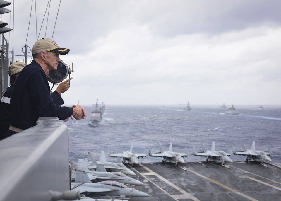 US Navy Rear Adm. Bill Byrne, commander of Carrier Strike Group 11, observes Indian, Japanese, and US ships from the aircraft carrier USS Nimitz during Malabar 2017 in the Bay of Bengal, July 17, 2017. (US Navy photo by Mass Communication Specialist 2nd Class Holly L. Herline)