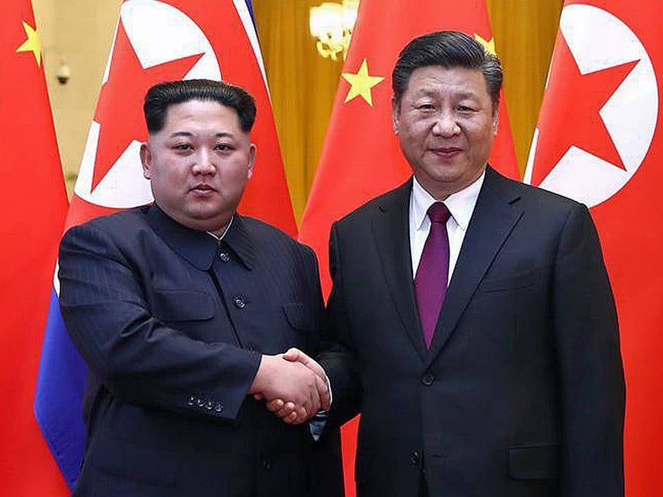 Kim Jong Un and Xi Jinping. (Xinhua News)