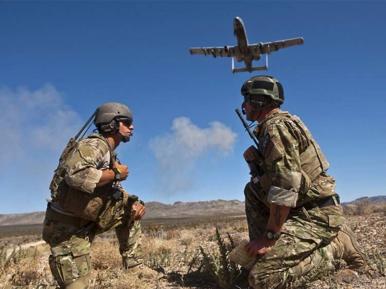 US Air Force Senior Airman Corban Caliguire and Tech. Sgt. Aaron Switzer, 21st Special Tactics Squadron joint terminal attack controllers (JTAC), call for an A-10 Thunderbolt II aircraft to do a show of force during a close air support training mission Sept. 23, 2011, at the Nevada Test and Training
